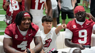 Aug. 4, 2025; Tuscaloosa, AL, USA; Alabama Crimson Tide players and coaches participate in a media day with reporters and fans at the Hank Crisp Indoor Practice Facility. Jace plays a college football vide game with running backs Daniel Hill (4) and Richard Young (9).
