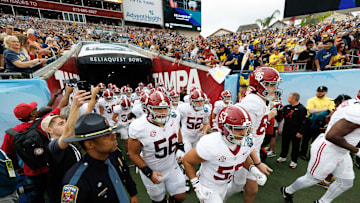 Dec 31, 2024; Tampa, FL, USA; Alabama Crimson Tide linebacker Vito Perri (53) and Alabama Crimson Tide punter James Burnip (86) lead the team onto the field before a game against the Michigan Wolverines at Raymond James Stadium. Mandatory Credit: Matt Pendleton-Imagn Images