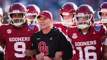 Oklahoma coach Brent Venables locks arms with players before the Armed Forces Bowl football game between the University of Oklahoma Sooners (OU) and the Navy Midshipmen at Amon G. Carter Stadium in Fort Worth, Texas, Friday, Dec. 27, 2024. Navy won 21-20.
