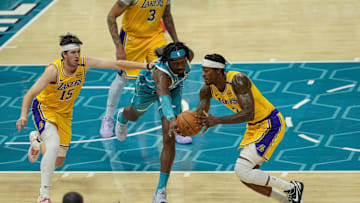 Jan 27, 2025; Charlotte, North Carolina, USA; Charlotte Hornets center Mark Williams (5) tries for a steal from Los Angeles Lakers forward Jarred Vanderbilt (2) during the second half at the Spectrum Center. Mandatory Credit: Jim Dedmon-Imagn Images