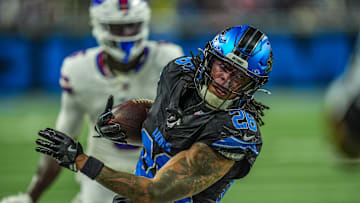 Detroit Lions running back Jahmyr Gibbs (26) tip toes along th sideline to get a first down on a back toss from Detroit Lions wide receiver Amon-Ra St. Brown (14) in a trick play iduring the second half at Ford Field in Detroit on Sunday, Dec. 15, 2024.