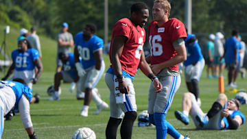 Detroit Lions quarterbacks Hendon Hooker and Jared Goff laugh after stretching during practice at the Lions training facility in Allen Park, Thursday, Aug. 14 2025