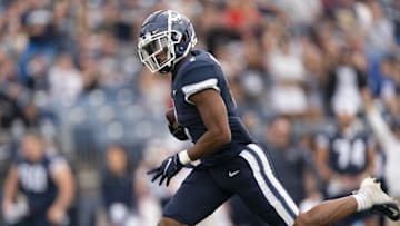 Oct 16, 2021; East Hartford, Connecticut, USA; Connecticut Huskies wide receiver Keelan Marion (1) runs with the ball after a catch for a touchdown against the Yale Bulldogs during the first half at Rentschler Field at Pratt & Whitney Stadium. Mandatory Credit: Gregory Fisher-Imagn Images