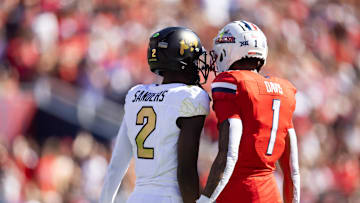 Oct 19, 2024; Tucson, Arizona, USA; Colorado Buffalos quarterback Shedeur Sanders (2) and Arizona Wildcats cornerback Tacario Davis (1) at Arizona Stadium. Mandatory Credit: Mark J. Rebilas-Imagn Images