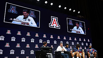 Oct 22, 2025; Kansas City, MO, USA; Arizona head coach Tommy Lloyd and players Tobe Awaka, Koa Peat and Jaden Bradley speaks to media during Big 12 Menís Basketball media day at T-Mobile Center. Mandatory Credit: Sophia Scheller-Imagn Images