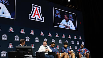 Oct 22, 2025; Kansas City, MO, USA; Arizona head coach Tommy Lloyd and players Tobe Awaka, Koa Peat and Jaden Bradley speaks to media during Big 12 Menís Basketball media day at T-Mobile Center. Mandatory Credit: Sophia Scheller-Imagn Images