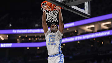Dec 17, 2024; Charlotte, North Carolina, USA; North Carolina Tar Heels forward Jalen Washington (13) with a dunk against the Florida Gators during the first half at Spectrum Center. Mandatory Credit: Jim Dedmon-Imagn Images