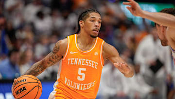 Tennessee guard Zakai Zeigler (5) looks for a path around Florida defenders during the second half of the Southeastern Conference tournament championship at Bridgestone Arena in Nashville, Tenn., Sunday, March 16, 2025.