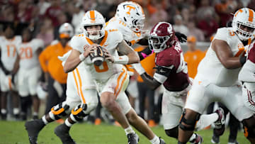 Oct 18, 2025; Tuscaloosa, Alabama, USA; Tennessee Volunteers quarterback Joey Aguilar (6) scrambles and looks for a receiver as he is pursued by Alabama Crimson Tide wide receiver Ben Jackson (42) in the second quarter at Saban Field at Bryant-Denny Stadium. Mandatory Credit: Gary Cosby-USA TODAY Network via Imagn Images