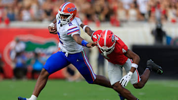 Florida Gators quarterback DJ Lagway (2) fends off Georgia Bulldogs defensive back KJ Bolden (4) during the second quarter of an NCAA college football matchup Saturday, Nov. 2, 2024 at EverBank Stadium in Jacksonville, Fla. The Georgia Bulldogs defeated the Florida Gators 34-20. [Corey Perrine/Florida Times-Union]