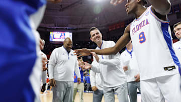 Jan 25, 2025; Gainesville, Florida, USA; Florida Gators head coach Todd Golden smiles in the huddle with Florida Gators center Rueben Chinyelu (9) after a game against the Georgia Bulldogs at Exactech Arena at the Stephen C. O'Connell Center. Mandatory Credit: Matt Pendleton-Imagn Images