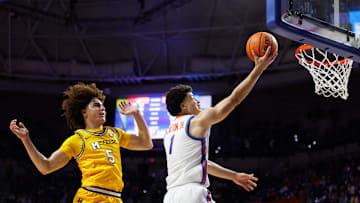 Jan 14, 2025; Gainesville, Florida, USA; Florida Gators guard Walter Clayton Jr. (1) makes a layup over Missouri Tigers guard T.O. Barrett (5) during the second half at Exactech Arena at the Stephen C. O'Connell Center. Mandatory Credit: Matt Pendleton-Imagn Images