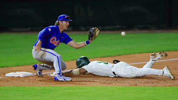 Jacksonville outfielder Jaden Bastian (8) beats the tag at third base from Florida utility Bobby Boser (6) during the fifth inning of an NCAA baseball matchup Monday, Feb. 17, 2025 at Jacksonville University in Jacksonville, Fla. Florida defeated Jacksonville 10-4. [Corey Perrine/Florida Times-Union]