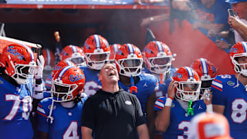 Sep 6, 2025; Gainesville, Florida, USA; Florida Gators head coach Billy Napier screams while surrounded by his team before a game against the South Florida Bulls at Ben Hill Griffin Stadium. Mandatory Credit: Matt Pendleton-Imagn Images