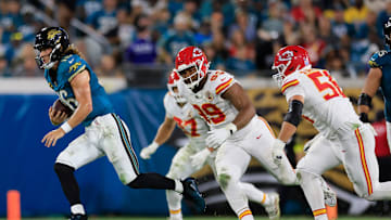Jacksonville Jaguars quarterback Trevor Lawrence (16) rushes for yards against Kansas City Chiefs defensive tackle Jerry Tillery (99) and defensive end George Karlaftis (56) during the second quarter of an NFL football matchup at EverBank Stadium, Monday, Oct. 6, 2025, in Jacksonville, Fla. [Corey Perrine/Florida Times-Union]