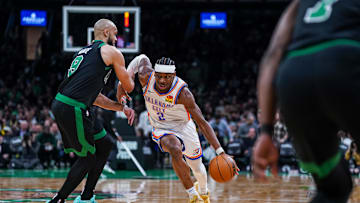 Mar 12, 2025; Boston, Massachusetts, USA; Oklahoma City Thunder guard Shai Gilgeous-Alexander (2) drives the ball against Boston Celtics guard Derrick White (9) in the third quarter at TD Garden. Mandatory Credit: David Butler II-Imagn Images