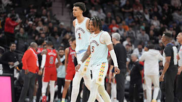 Dec 8, 2024; San Antonio, Texas, USA;  San Antonio Spurs center Victor Wembanyama (1) and guard Stephon Castle (5) walk toward the bench in the second half against the New Orleans Pelicans at Frost Bank Center. Mandatory Credit: Daniel Dunn-Imagn Images