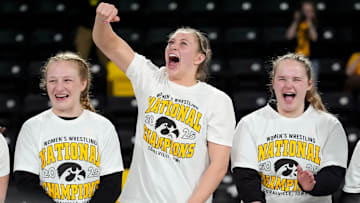 Iowa’s Macey Kilty, Kylie Welker and Jaycee Foeller celebrate after the team’s first-place finish at NCWWC’s Saturday, March 8, 2025 at Xtream Arena in Coralville, Iowa.