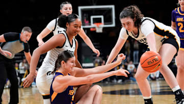 Ashland forward Katelyn Harabedian (7) passes the ball as Iowa forward Hannah Stuelke (45) and Iowa center Ava Heiden (5) defend Oct. 30, 2025 during an exhibition game at Carver-Hawkeye Arena in Iowa City, Iowa.