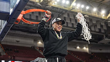 March 9, 2025; Greenville, SC, USA;  South Carolina Gamecocks head coach Dawn Staley cuts the net down  after the win over Texas in the SEC womenís championship  at Bon Secours Wellness Arena. Mandatory Credit: Jim Dedmon-Imagn Images