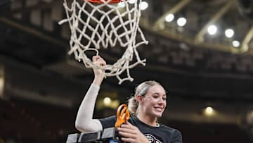 March 9, 2025; Greenville, SC, USA;  South Carolina Gamecocks forward Chloe Kitts (21) cuts the net after the win over Texas in the SEC womenís championship  at Bon Secours Wellness Arena. Mandatory Credit: Jim Dedmon-Imagn Images