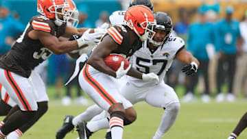 Cleveland Browns running back Pierre Strong Jr. (20) rushes for yards as Jacksonville Jaguars linebacker Caleb Johnson (57) makes the tackle during the second quarter of an NFL football matchup Sunday, Sept. 15, 2024 at EverBank Stadium in Jacksonville, Fla. The Browns defeated the Jaguars 18-13. [Corey Perrine/Florida Times-Union]