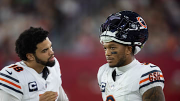 Nov 3, 2024; Glendale, Arizona, USA; Chicago Bears quarterback Caleb Williams (18) talks with wide receiver DJ Moore (2) against the Arizona Cardinals at State Farm Stadium. Mandatory Credit: Mark J. Rebilas-Imagn Images