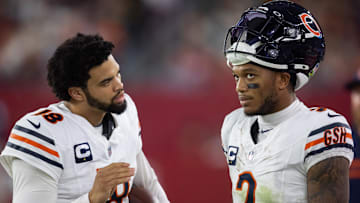 Nov 3, 2024; Glendale, Arizona, USA; Chicago Bears quarterback Caleb Williams (18) talks with wide receiver DJ Moore (2) against the Arizona Cardinals at State Farm Stadium. Mandatory Credit: Mark J. Rebilas-Imagn Images