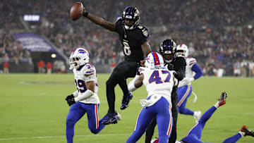 Sep 29, 2024; Baltimore, Maryland, USA; Baltimore Ravens quarterback Lamar Jackson (8) leaps across the goal line for a touchdown as Buffalo Bills cornerback Christian Benford (47) and Bills cornerback Cam Lewis (39) defend at M&T Bank Stadium. Mandatory Credit: Geoff Burke-Imagn Images