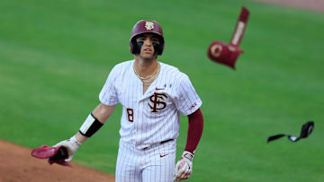Florida St. outfielder Max Williams (18) tosses his batting guards before taking first base during the first inning of an NCAA college baseball matchup Tuesday, March 25, 2025 at VyStar Ballpark in Jacksonville, Fla. FSU rallied to defeat UF 8-4 off a walk-off grand slam from Alex Lodise in the ninth inning. [Corey Perrine/Florida Times-Union]
