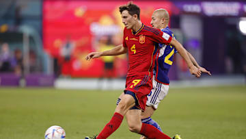 Dec 1, 2022; Doha, Qatar; Spain defender Pau Torres (4) kicks the ball against Japan during the second half of a group stage match during the 2022 World Cup at Khalifa International Stadium. Mandatory Credit: Yukihito Taguchi-Imagn Images