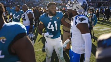 Jacksonville Jaguars linebacker Josh Allen (41) greets Carolina Panthers linebacker Brian Burns (0) at EverBank Stadium in Jacksonville, Fla.