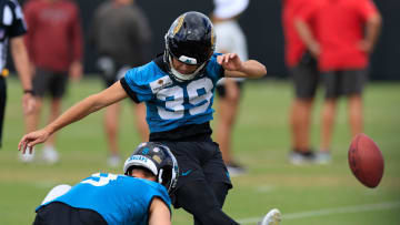 Jacksonville Jaguars place kicker Cam Little (39) kicks as punter Logan Cooke (9) holds during a combined NFL football training camp session between the Tampa Bay Buccaneers and Jacksonville Jaguars Thursday, Aug. 15, 2024 at EverBank Stadium’s Miller Electric Center in Jacksonville, Fla. 