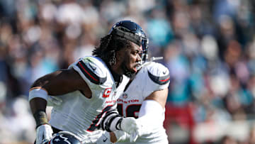 Dec 1, 2024; Jacksonville, Florida, USA;Houston Texans linebacker Azeez Al-Shaair (0) is held back by Houston Texans linebacker Henry To'oTo'o (39) after being ejected against the Jacksonville Jaguars in the second quarter  at EverBank Stadium. Mandatory Credit: Nathan Ray Seebeck-Imagn Images