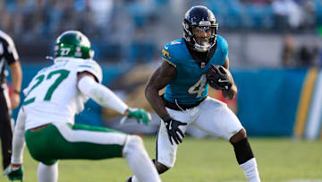 Jacksonville Jaguars running back Tank Bigsby (4) rushes for yards against New York Jets cornerback Kendall Sheffield (27) during the fourth quarter Sunday, Dec. 15, 2024 at EverBank Stadium in Jacksonville, Fla.