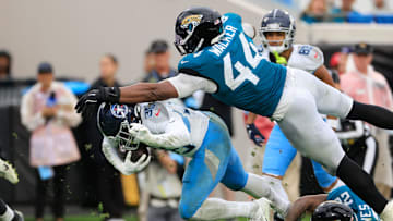 Jacksonville Jaguars defensive end Travon Walker (44) and cornerback Jarrian Jones (22) combine to tackle Tennessee Titans running back Julius Chestnut (36) during the fourth quarter Sunday, Dec. 29, 2024 at EverBank Stadium in Jacksonville, Fla. The Jaguars held off the Titans 20-13. [Corey Perrine/Florida Times-Union]
