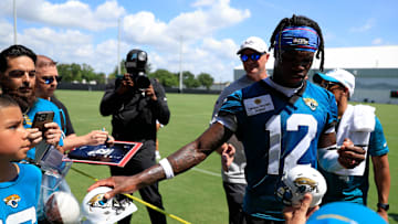 Jacksonville Jaguars wide receiver Travis Hunter (12) signs autographs for fans during the second mandatory minicamp at Miller Electric Center Wednesday, June 11, 2025 in Jacksonville, Fla.
