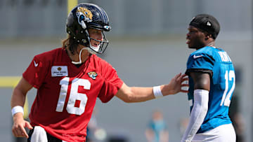 Jacksonville Jaguars quarterback Trevor Lawrence (16) talks technique with wide receiver Travis Hunter (12) after an NFL training camp session at the Miller Electric Center, Sunday, Aug. 3, 2025, in Jacksonville, Fla. [Corey Perrine/Florida Times-Union]