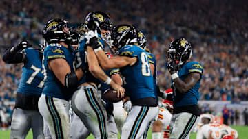 Jacksonville Jaguars quarterback Trevor Lawrence (16) is celebrated by offensive tackle Patrick Mekari (65) and tight end Hunter Long (84) for his touchdown score with other teammates joining in for his game-winning touchdown during the fourth quarter of an NFL football matchup at EverBank Stadium, Monday, Oct. 6, 2025, in Jacksonville, Fla