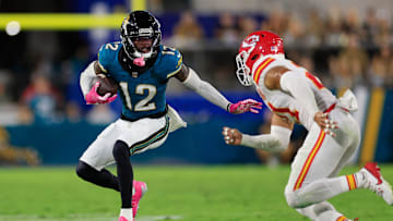 Jacksonville Jaguars wide receiver Travis Hunter (12) is pressured by Kansas City Chiefs safety Jaden Hicks (21) during the third quarter of an NFL football matchup at EverBank Stadium, Monday, Oct. 6, 2025, in Jacksonville, Fla. The Jacksonville Jaguars edged the Kansas City Chiefs 31-28. 