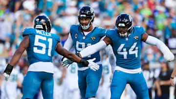 Jacksonville Jaguars linebacker Ventrell Miller (51) is high-fived by defensive end Travon Walker (44) as defensive tackle Arik Armstead (91) looks on during the fourth quarter of an NFL football matchup, Sunday, Oct. 12, 2025, at EverBank Stadium in Jacksonville, Fla. The Seahawks defeated the Jaguars 20-12.