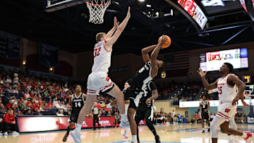 Nov 27, 2025; San Diego, CA, USA; Providence Friars forward Jamier Jones (5) shoots the ball against Wisconsin Badgers forward Aleksas Bieliauskas (32) during the first half at Jenny Craig Pavilion.