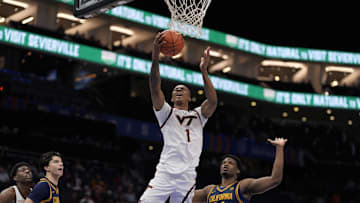 Mar 11, 2025; Charlotte, NC, USA; Virginia Tech Hokies forward Tobi Lawal (1) goes to the basket defended but California Golden Bears forward Lee Dort (34) during the second half at Spectrum Center. Mandatory Credit: Jim Dedmon-Imagn Images