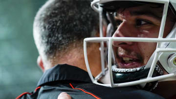 Oct 21, 2023; Miami Gardens, Florida, USA; Miami Hurricanes quarterback Emory Williams (17) embraces Miami Hurricanes head coach Mario Cristobal after defeating the Clemson Tigers at Hard Rock Stadium. Mandatory Credit: Rich Storry-USA TODAY Sports