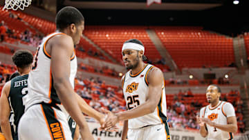 Feb 25, 2025; Stillwater, Oklahoma, USA; Oklahoma State Cowboys forward Robert Jennings II (25) slaps hands with Oklahoma State Cowboys forward Abou Ousmane (33) after a play during the first half against the Iowa State Cyclones at Gallagher-Iba Arena. Mandatory Credit: William Purnell-Imagn Images