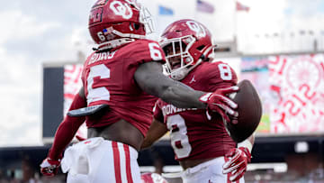 Oklahoma wide receiver Deion Burks and Oklahoma running back Taylor Tatum 