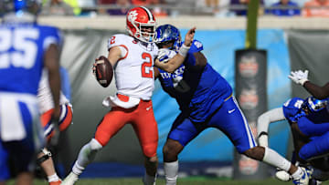 Kentucky Wildcats defensive lineman Deone Walker (0) sacks Clemson Tigers quarterback Cade Klubnik (2) during the second quarter of an NCAA football matchup in the TaxSlayer Gator Bowl Friday, Dec. 29, 2023