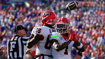 Georgia Bulldogs wide receiver Dillon Bell (86) reacts to scoring a touchdown with teammate wide receiver Zachariah Branch (1) during the first quarter of an NCAA football game, Saturday, Nov. 1, 2025, at EverBank Stadium in Jacksonville, Fla. Georgia held off Florida 24-20. 