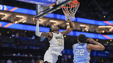 Mar 13, 2025; Charlotte, NC, USA; Wake Forest Demon Deacons forward Tre'Von Spillers (25) tries for a layup defended by North Carolina Tar Heels forward Ven-Allen Lubin (22) during the second half at Spectrum Center. Mandatory Credit: Jim Dedmon-Imagn Images