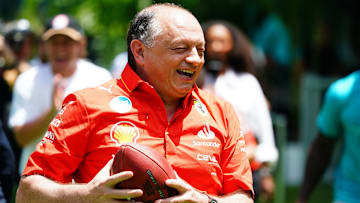 May 2, 2024; Miami Gardens, Florida, USA;  Ferrari team principal Frederic Vasseur 
bobbles a catch as he takes part in a NFL football punt catch challenge alongside Miami Dolphins players in advance of the Miami Grand Prix at the Miami International Autodrome. Mandatory Credit: John David Mercer-Imagn Images